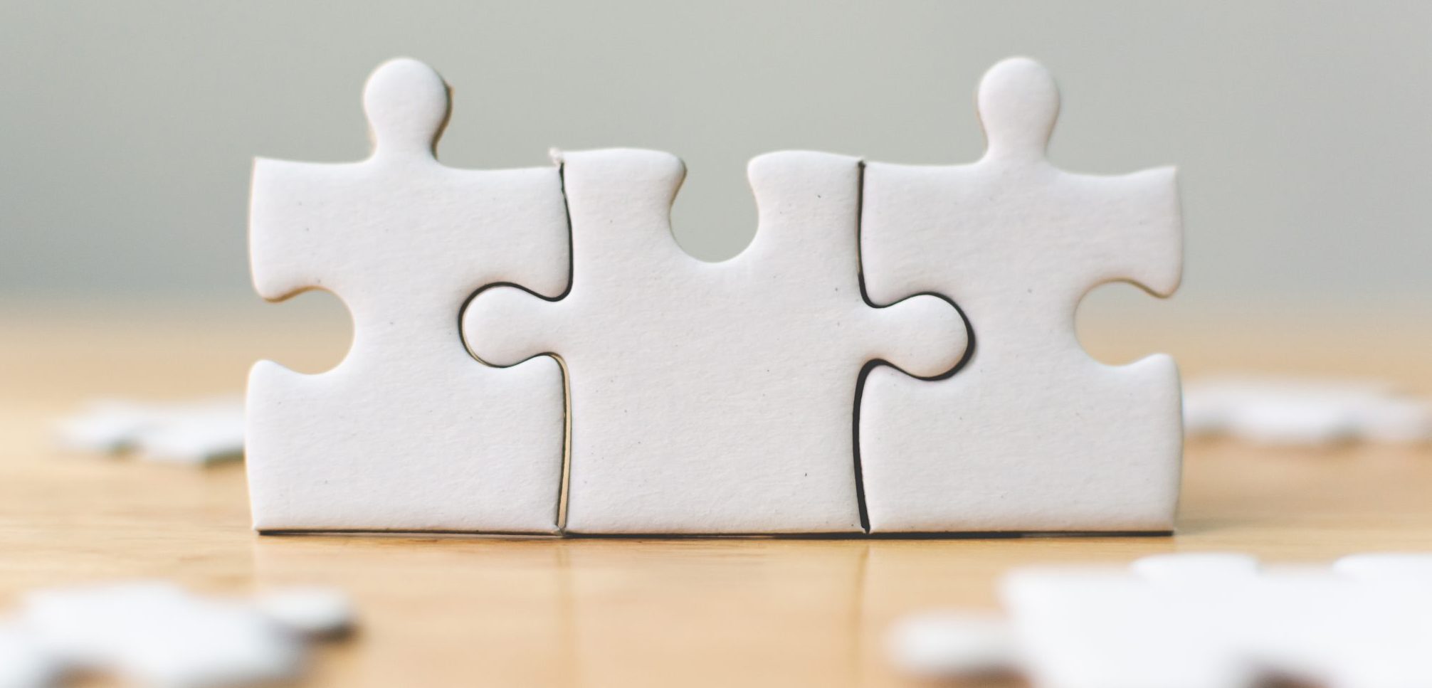 three pieces of white jigsaw puzzle connecting together