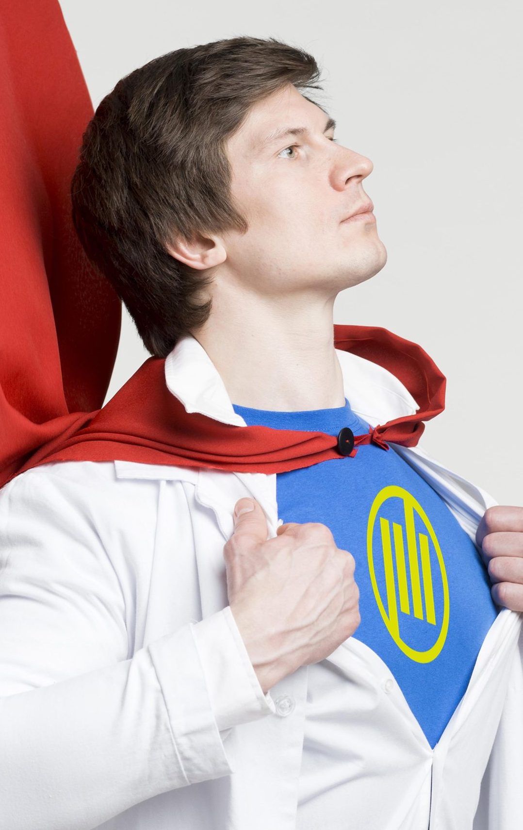 man wearing red superhero cape opening white dress shirt to reveal blue tshirt with presshero logo