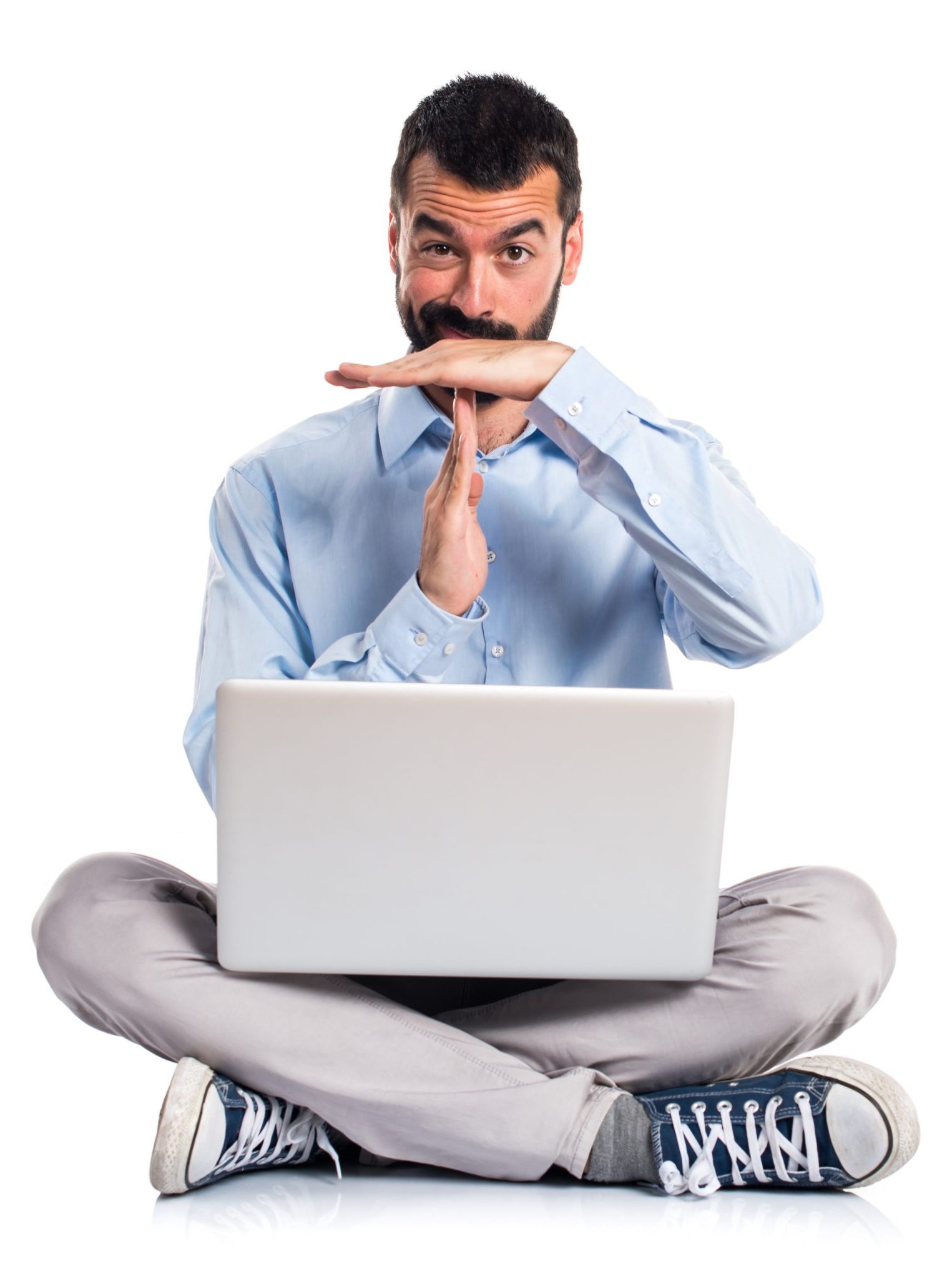 Man with laptop making time out gesture