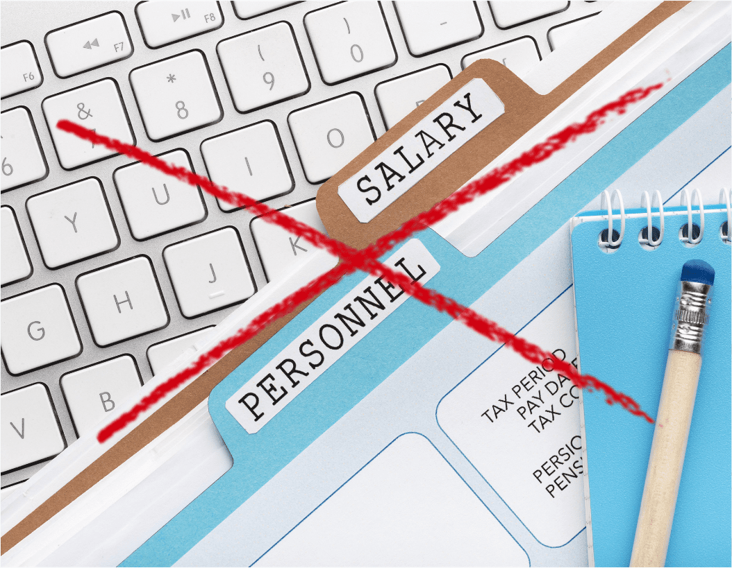 salary and personnel files on keyboard with red x over top