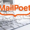 Email marketing symbolized by laptop with many envelopes floating around with MailPoet logo on top